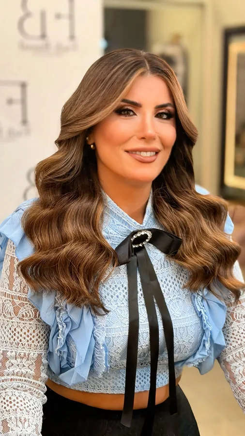 Long brown hair styled in polished waves