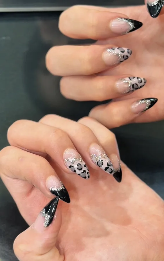 Black and leopard-pattern nails with silver accents