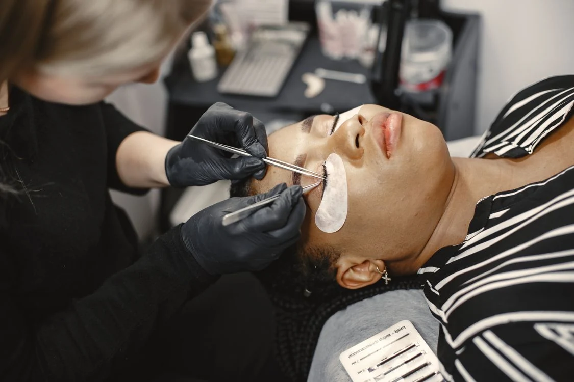 Close-up of a professional applying eyelash extensions